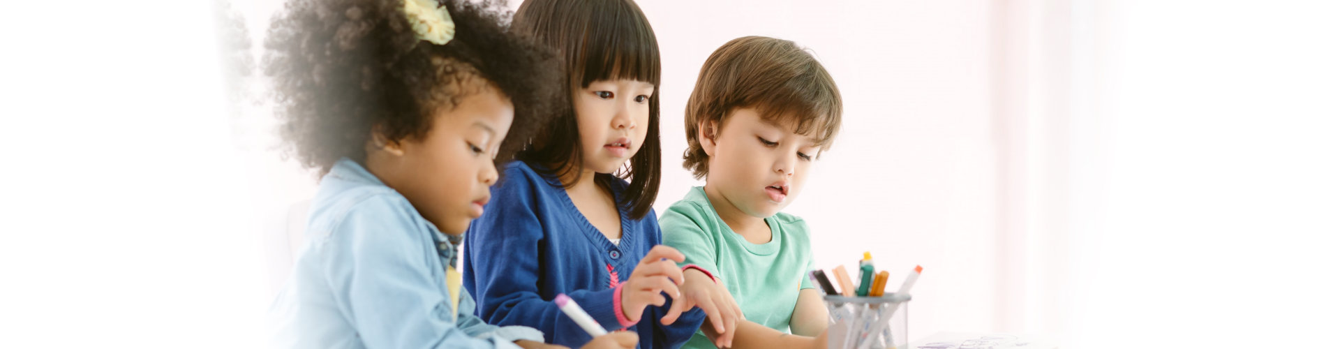 Group of diversity kids drawing and painting with crayon together with fun in art class